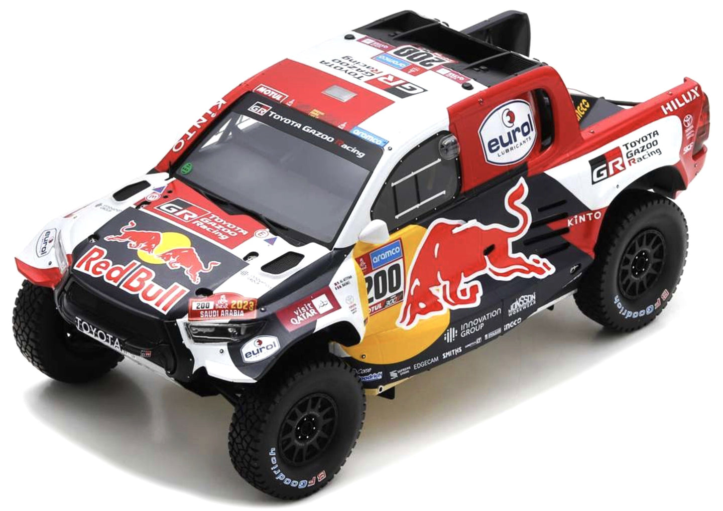 TOYOTA HILUX T1 GR DKR PICK-UP TEAM TOYOTA GAZOO RACING RED BULL N 200 WINNER RALLY DAKAR 2023 NASSER AL-ATTIYAH - MATHIEU BAUMEL WHITE BLUE RED YELLOW 1:18